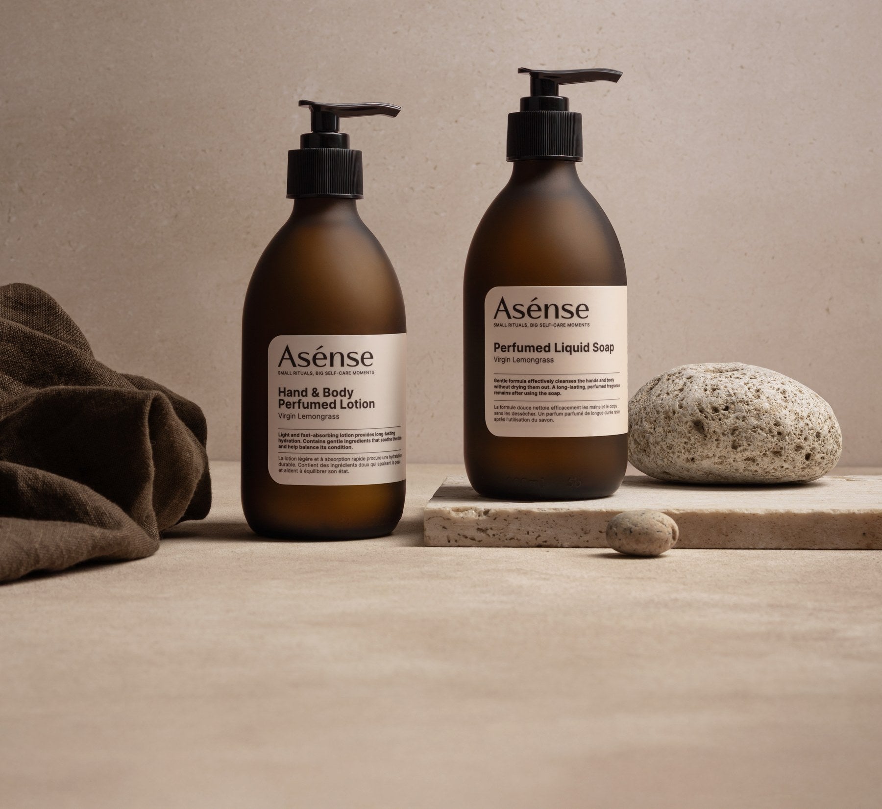 Asense hand and body lotion and liquid soap on a stone shelf
