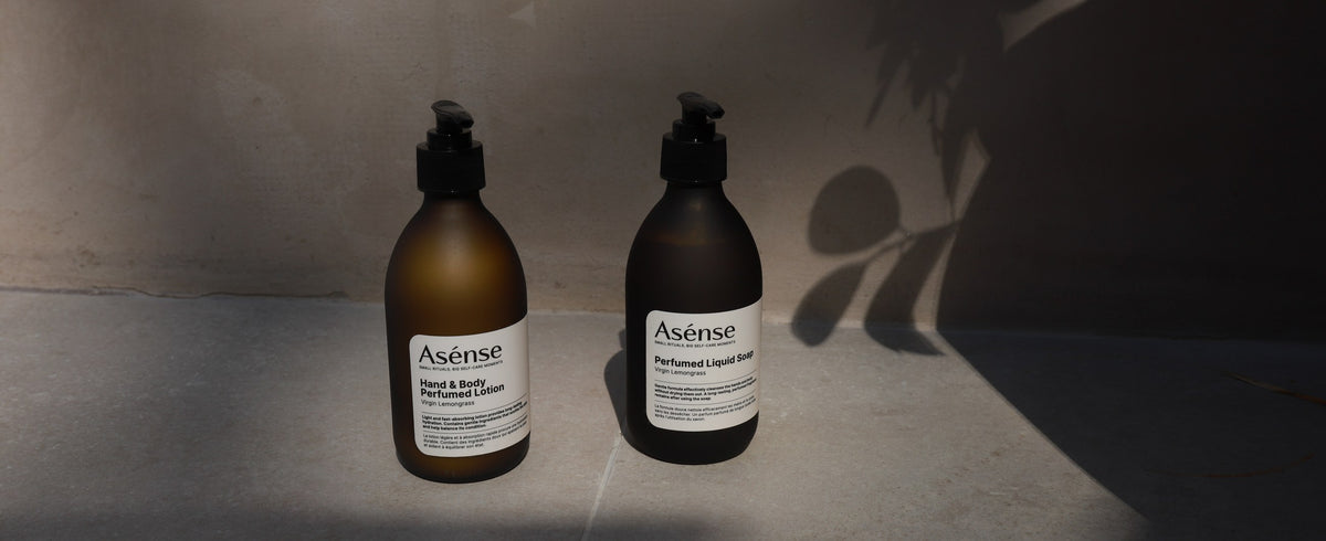 Asense lotion and liquid soap on a sunlit stone wall