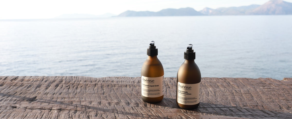 Asense liquid soap and body lotion on a deck by the sea